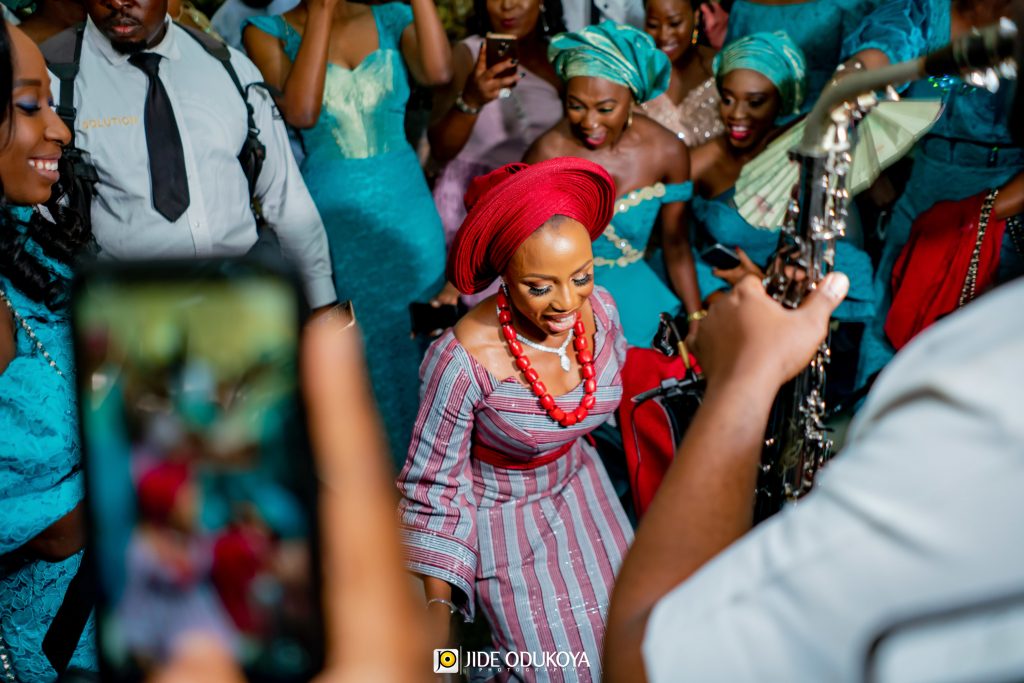 Kemi the bride dancing her way into the traditional ceremony while BeeJaySax plays