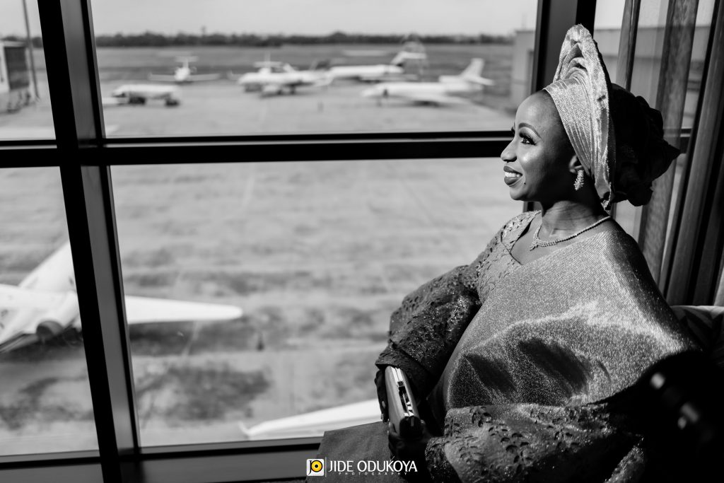 Kemi the bride looking ahead with airplanes in the background