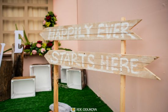 A wooden inscription with the words 'Happily Ever Starts Here'